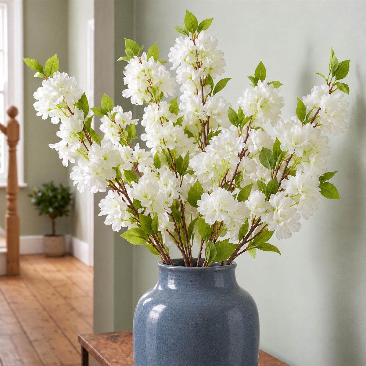 Pack of 6 x 100cm White Artificial Blossom Stem styled in a room