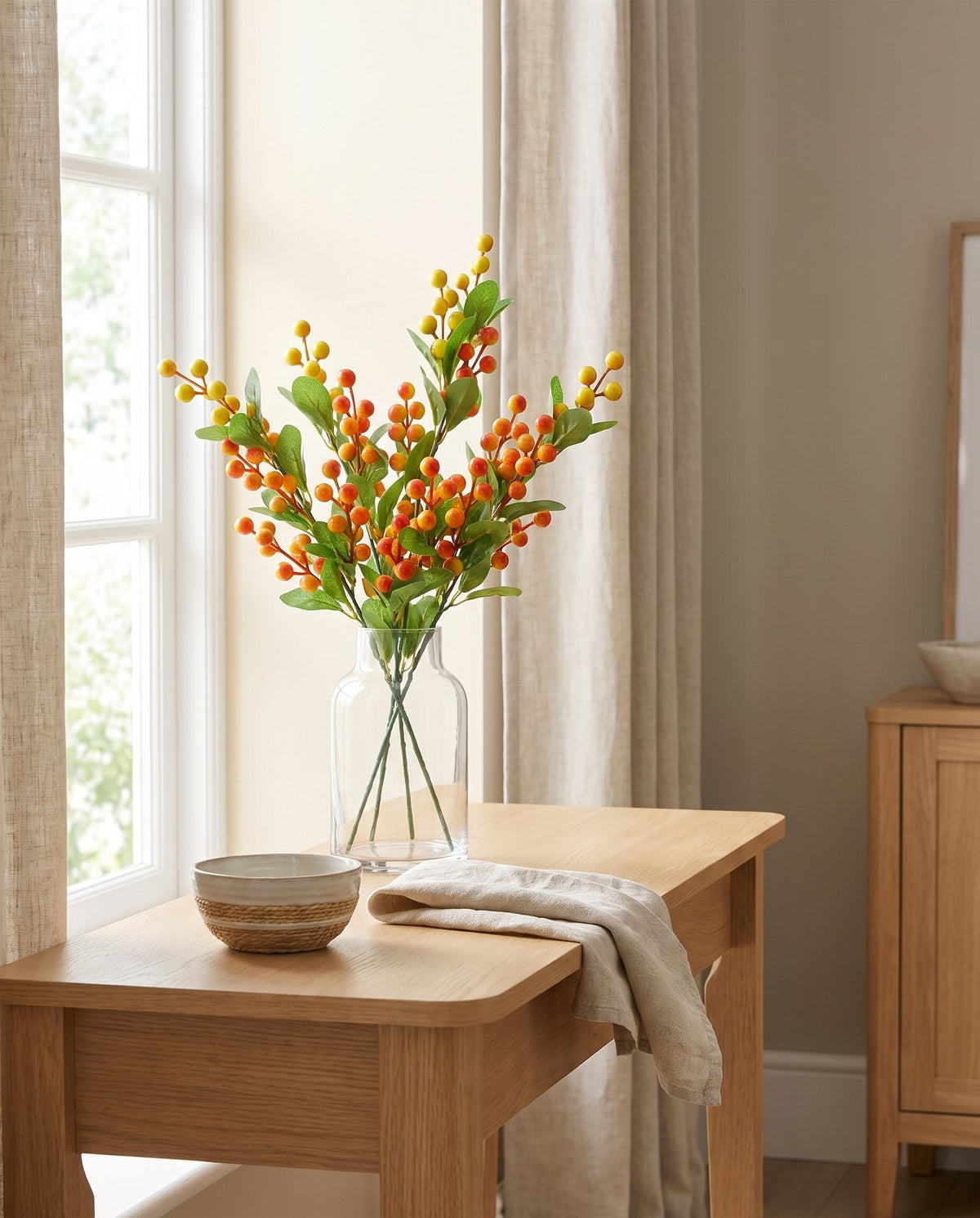 70cm Artificial Orange Berry Spray styled in a room