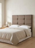 Charlotte headboard in Linoso Sand fabric on a made-up bed