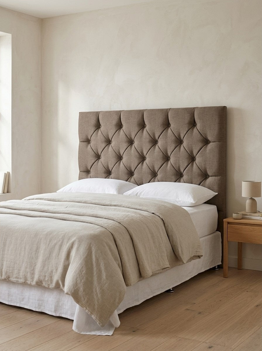 Whitby headboard in Linoso Sand fabric on a made-up bed