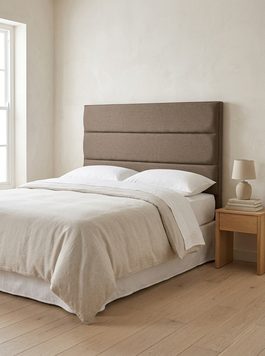 Ryedale headboard in Linoso Sand fabric on a made-up bed