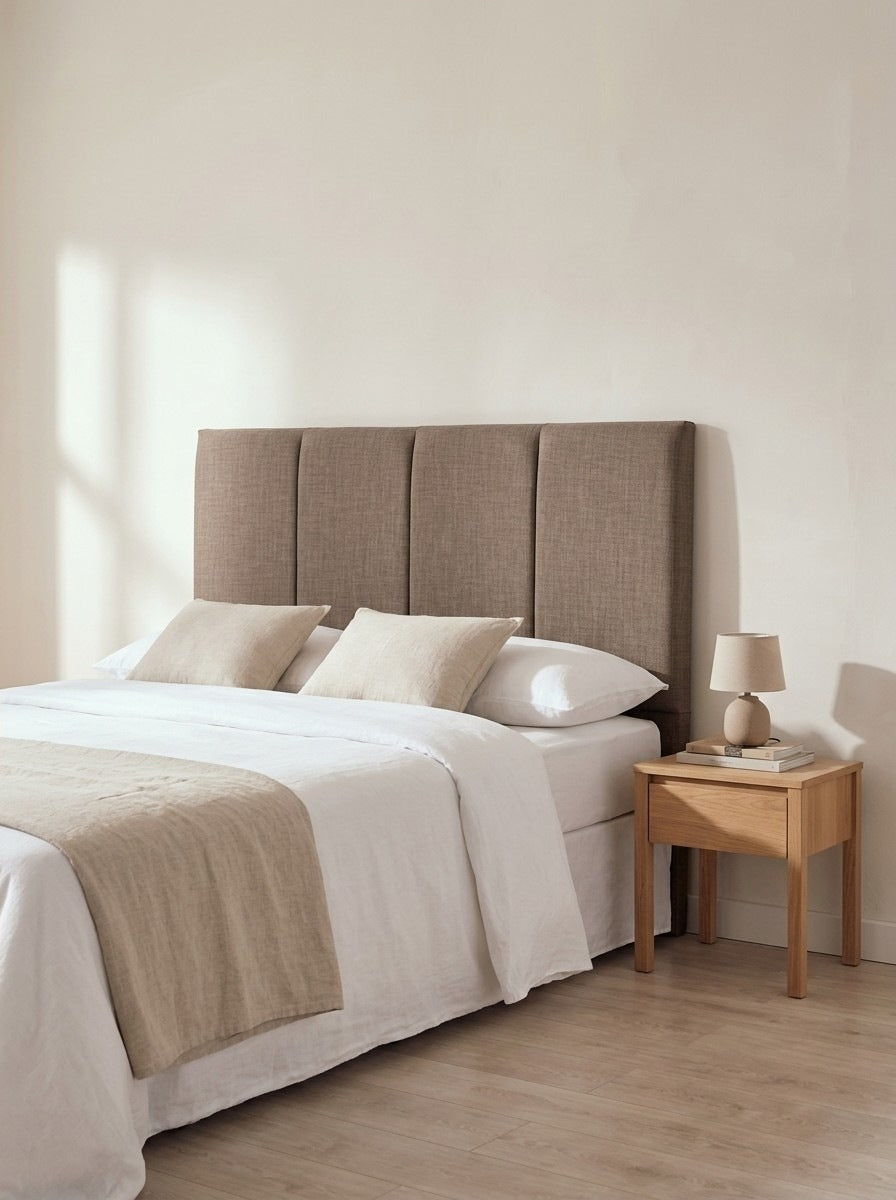 Hatton headboard in Linoso Sand fabric on a made-up bed