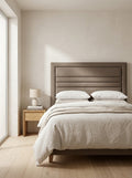Lily headboard in Linoso Sand fabric on a made-up bed