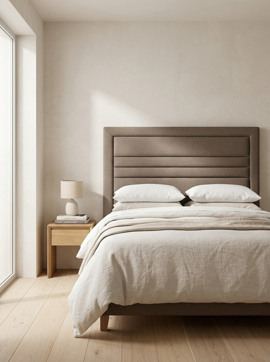Lily headboard in Linoso Sand fabric on a made-up bed