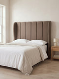 Macie headboard in Linoso Sand fabric on a made-up bed