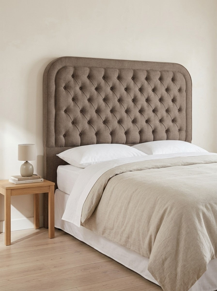 Ruby headboard in Linoso Sand fabric on a made-up bed