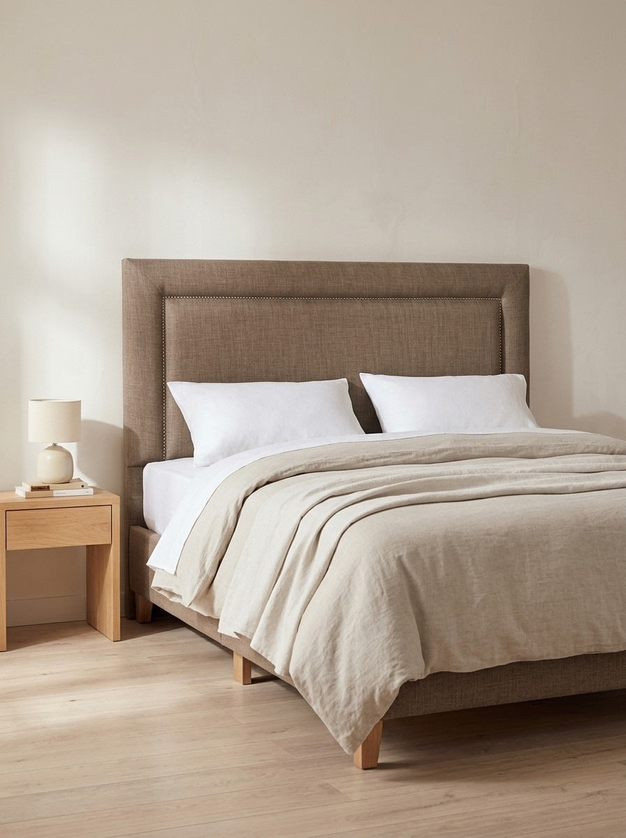 York headboard in Linoso Sand fabric on a made-up bed