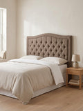 Willow headboard in Linoso Sand fabric on a made-up bed