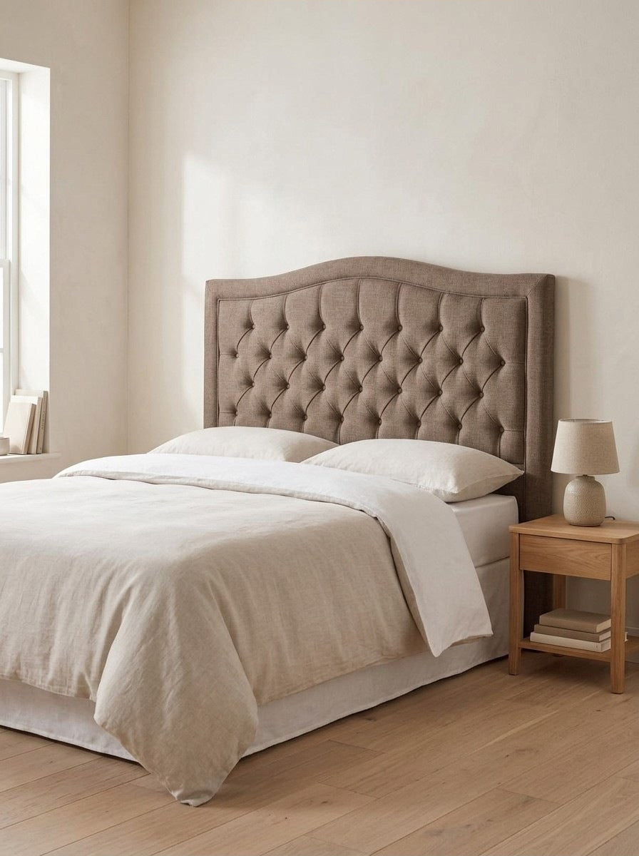 Willow headboard in Linoso Sand fabric on a made-up bed