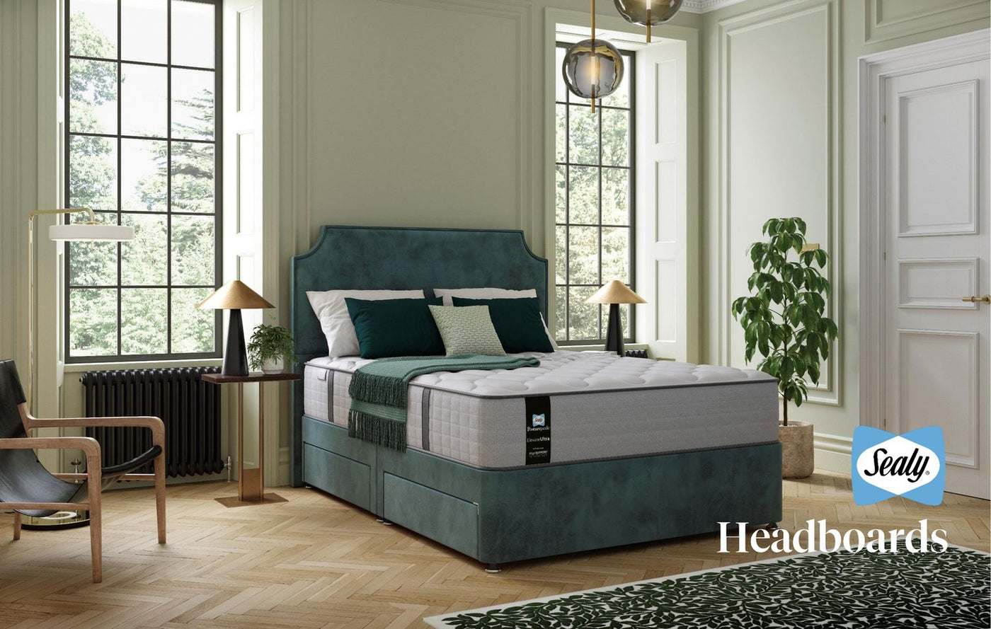 Sealy bed with upholstered headboard in a styled room
